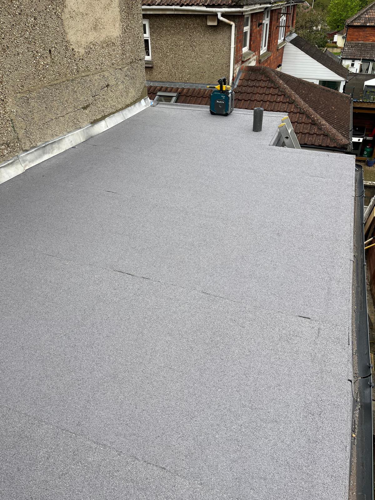 Torch-on felt flat roof with lead flashing detail