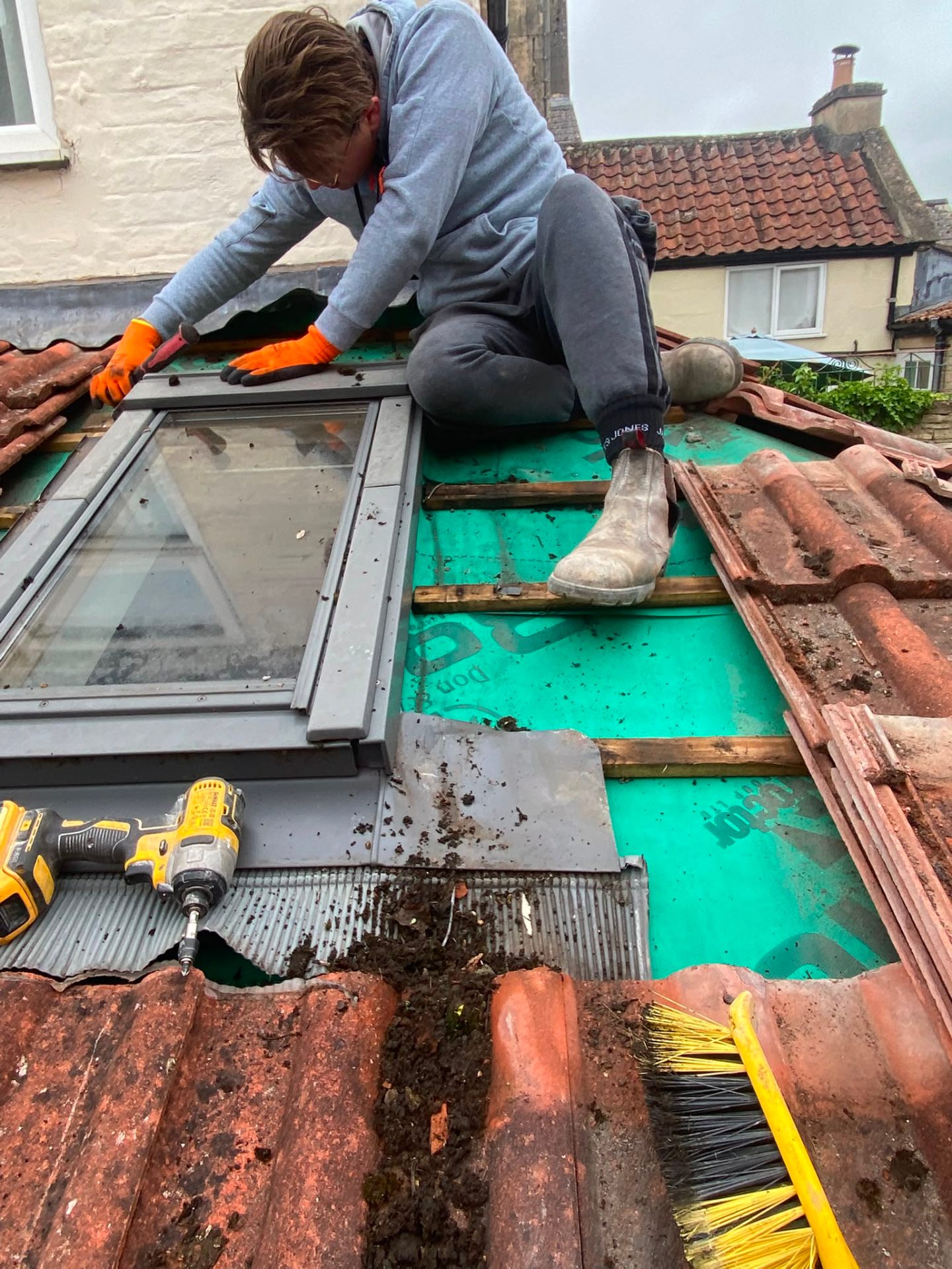 BC Roofing craftsman fitting a Velux skylight with lead soakers on a pitched tiled roof